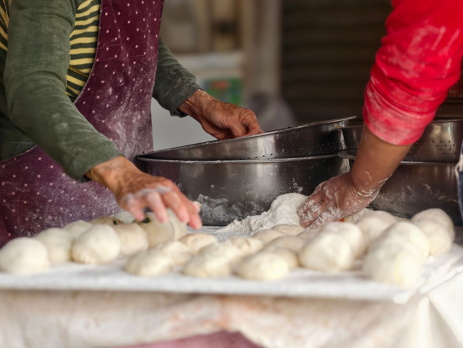 Équipe de boulangers travaillant la pâte dans un laboratoire artisanal